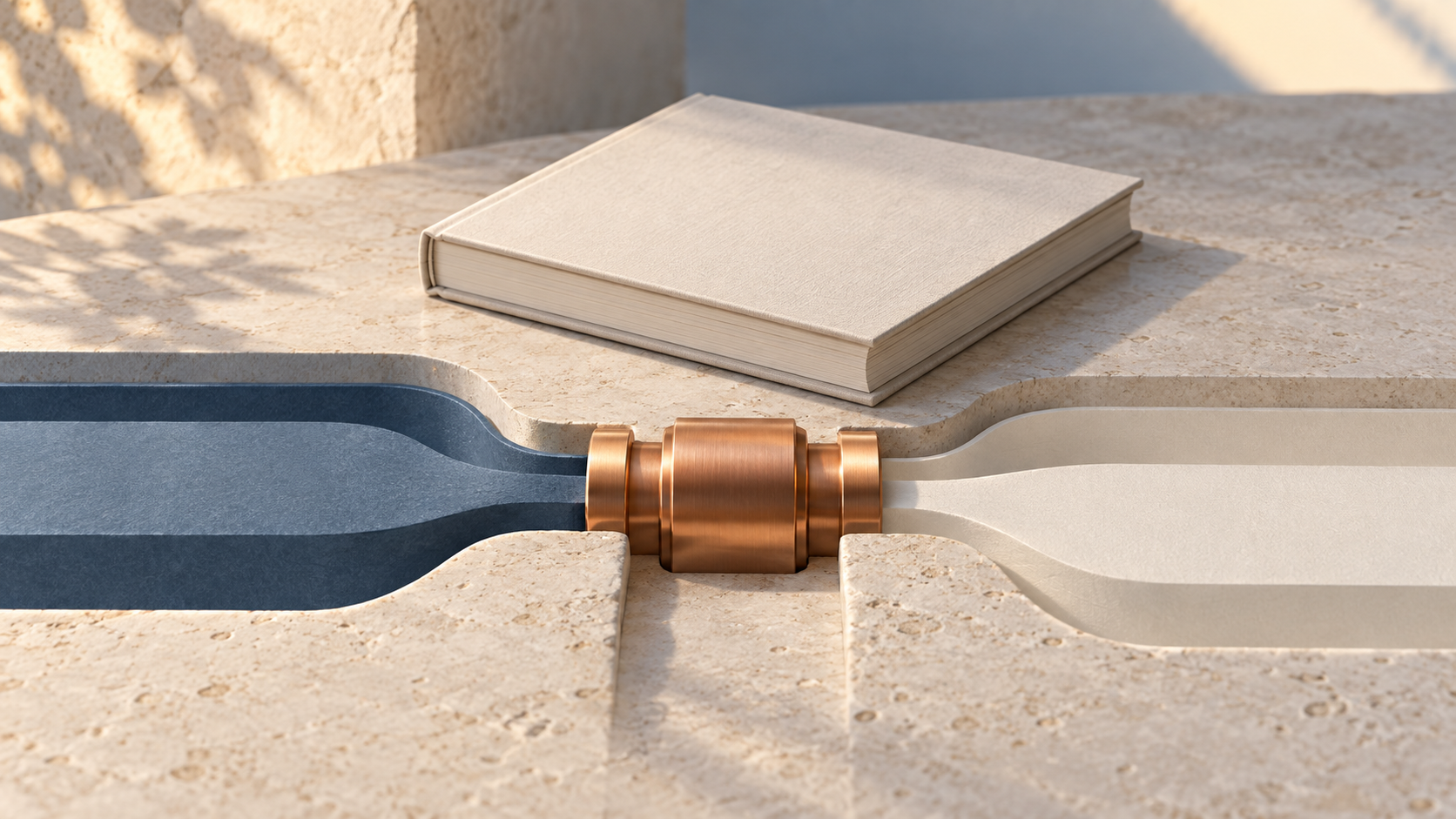 Copper connector joins two carved channels beside a blank rulebook in a conceptual sculpture.